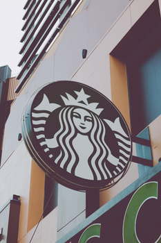 Close-up of Starbucks signage on a modern building facade in Los Angeles, CA. 15260921