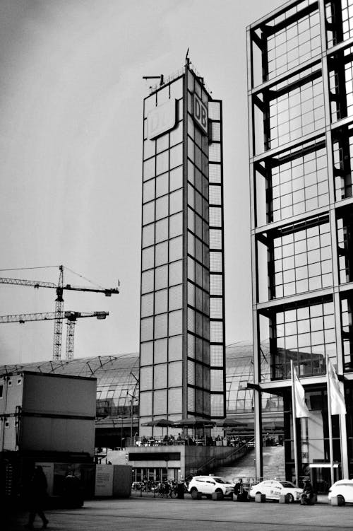 Grayscale Photo of Two Glass Buildings