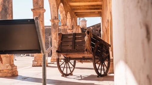 Old Wooden Carriage near Ancient Historic Building