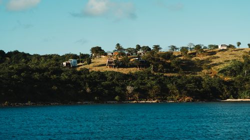 Free Charming hillside view with buildings along a scenic coastline under a clear sky. Stock Photo