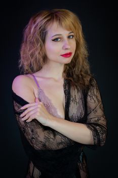 An elegant studio portrait of a woman in black lace lingerie showcasing beauty and confidence.