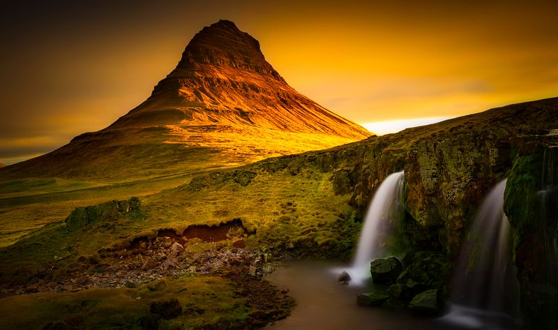 Kirkjufell mountain glowing at sunset in Iceland