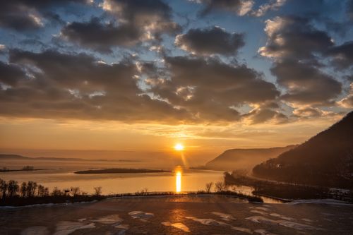 Free Golden sunrise over a serene river and landscape at Minneiska, Minnesota. Perfect for nature lovers. Stock Photo