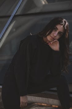 Portrait of a woman posing thoughtfully in an outdoor setting.