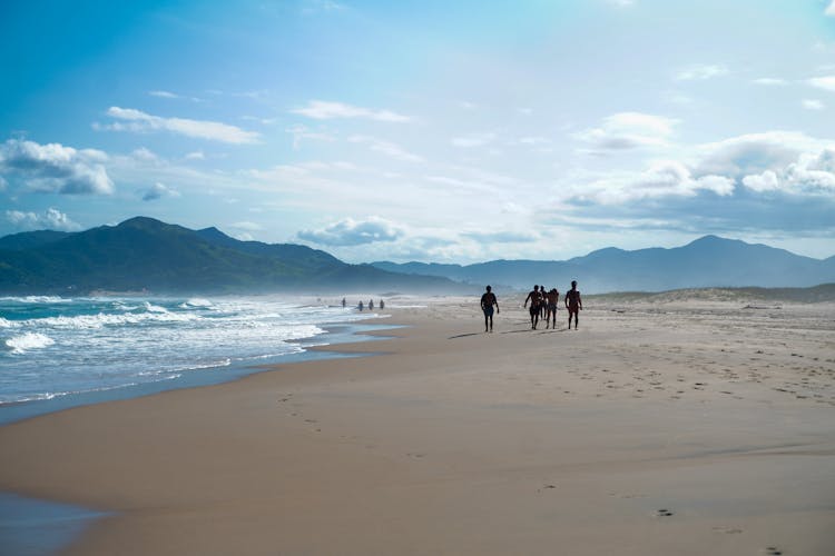 People Walking On The Beach