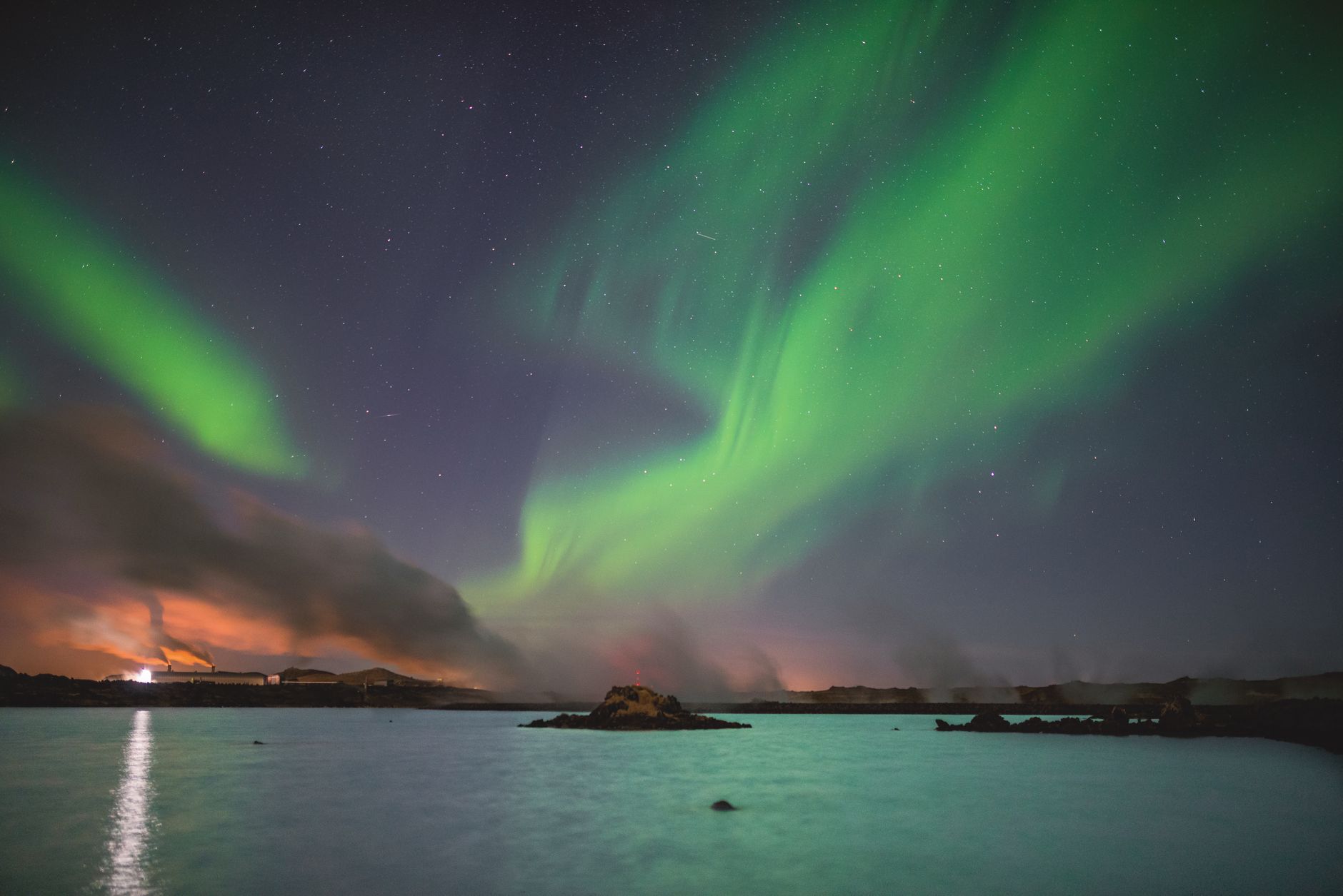 Northern lights dancing over Icelandic landscape