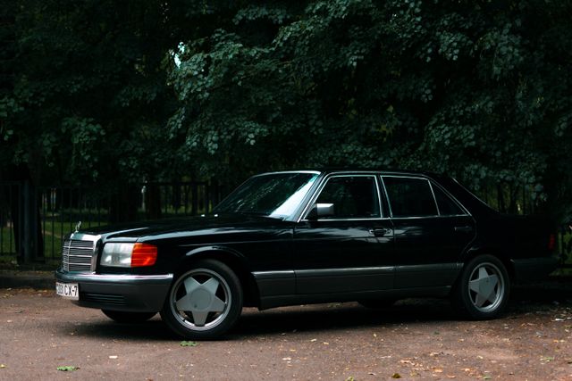 Dark sedan parked on a quiet street — photo by Vitali Adutskevich on Pexels