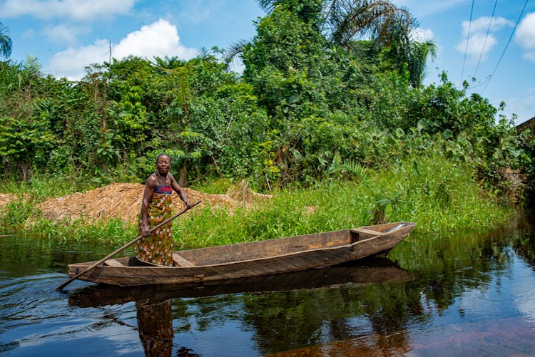 A Woman Riding On A Canoe