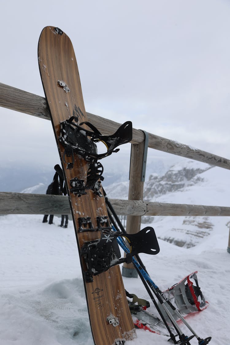 Snowboard By Wooden Railing