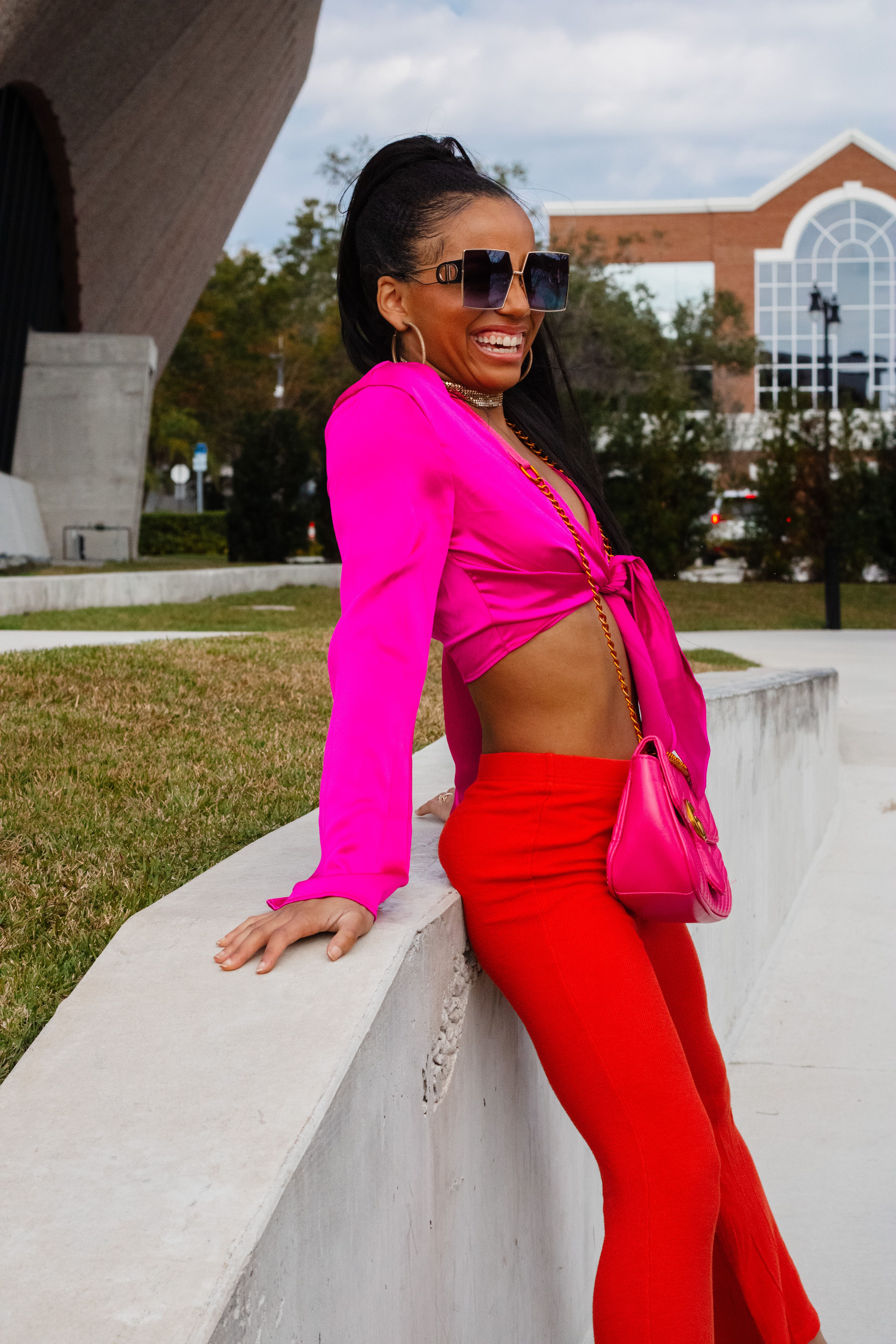 Smiling Woman Posing by Wall · Free Stock Photo