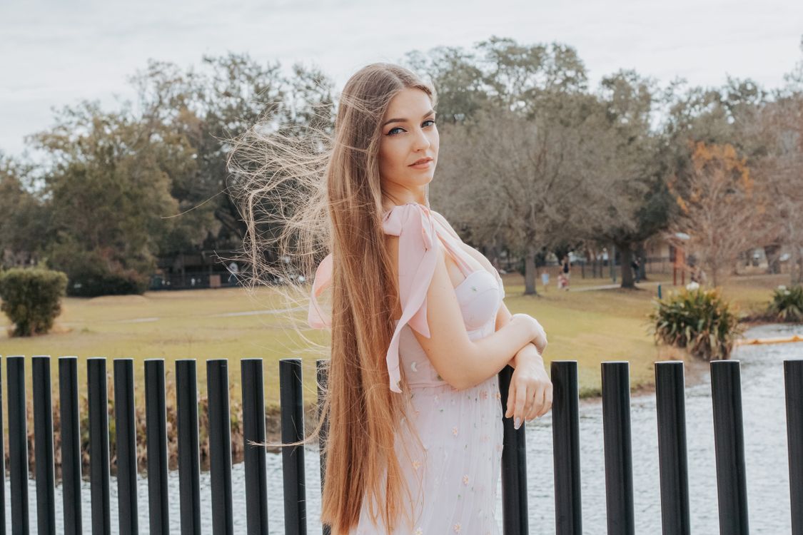 Woman with Long Hair Posing in Pink Dress · Free Stock Photo