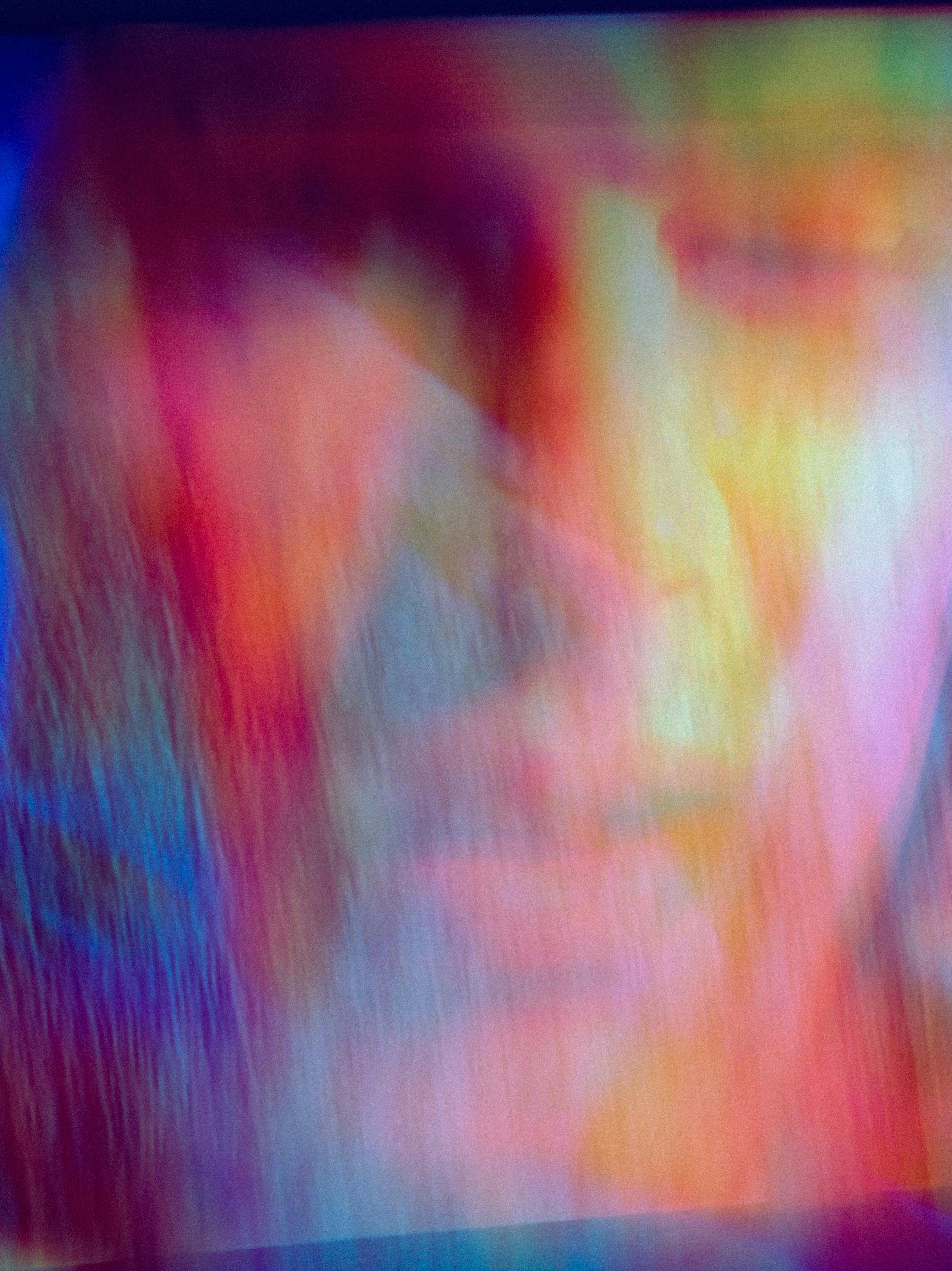 Vibrant abstract art featuring a blurred face with a rainbow of colors.