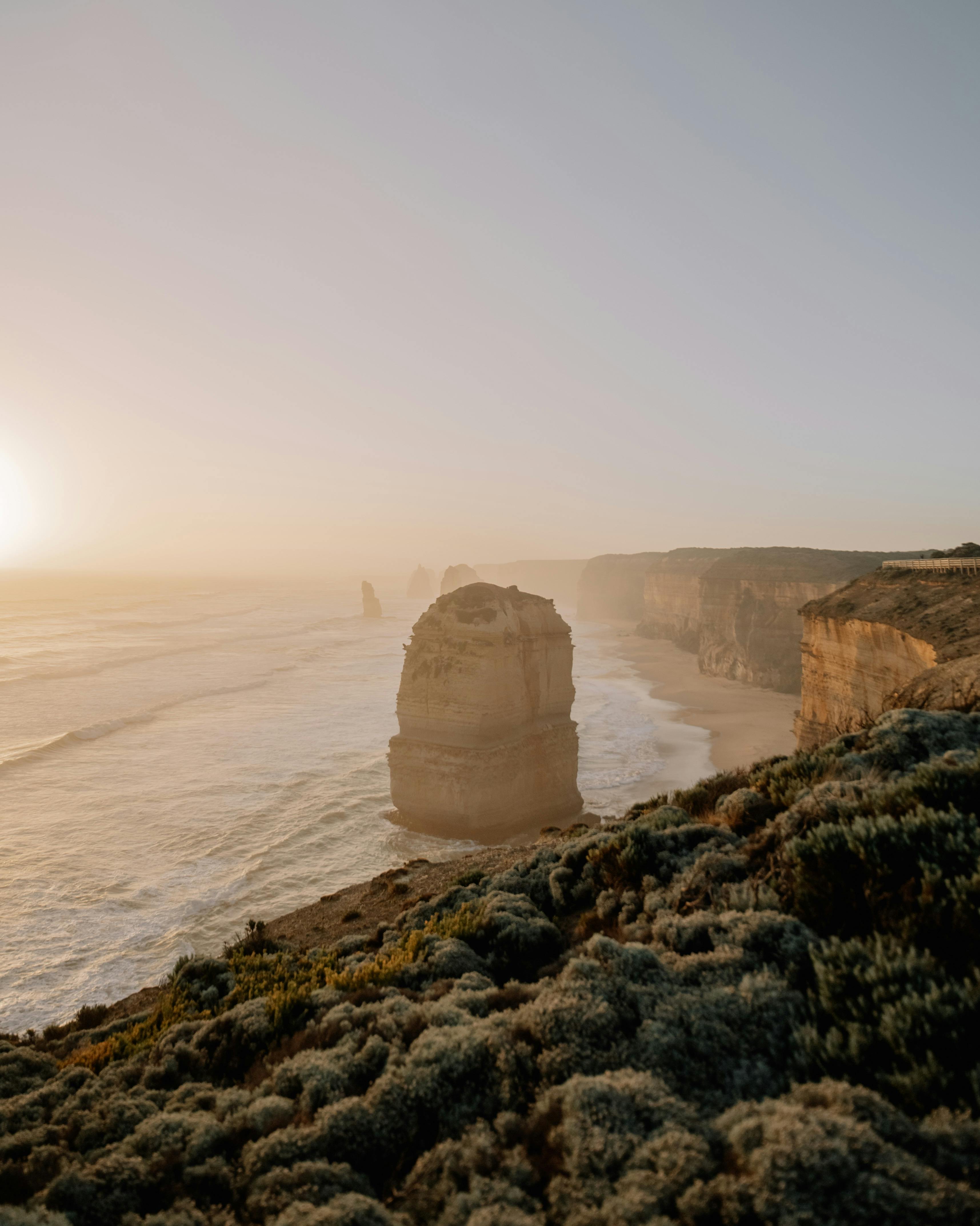 Stunning view of the Twelve Apostles rock formations along Australia's Great Ocean Road at sunset.