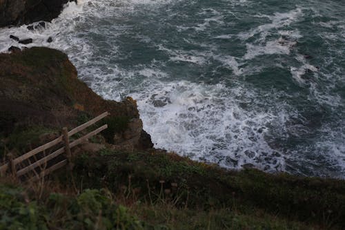 View of Waves Crashing on the Rocky Shore at Lizard Point in Cornwall, England, UK 