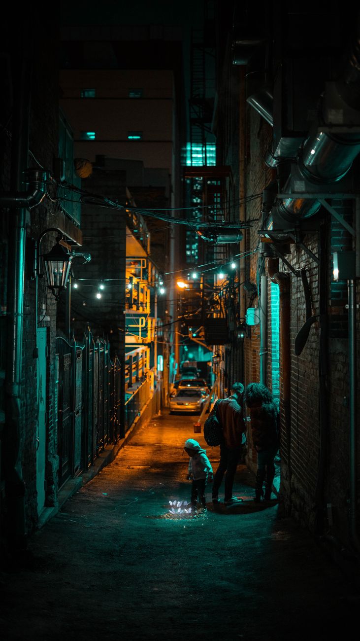 Atmospheric alley in Nashville at night with urban lighting casting shadows.