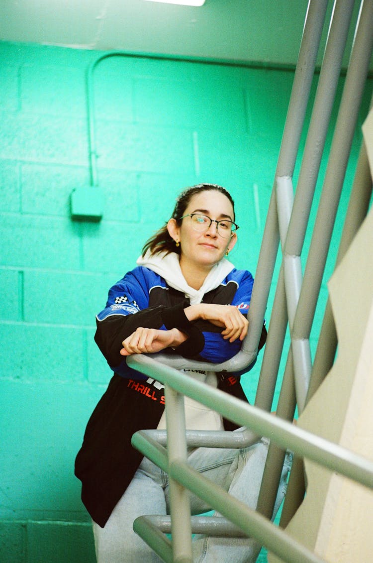 Woman Leaning On Handrail