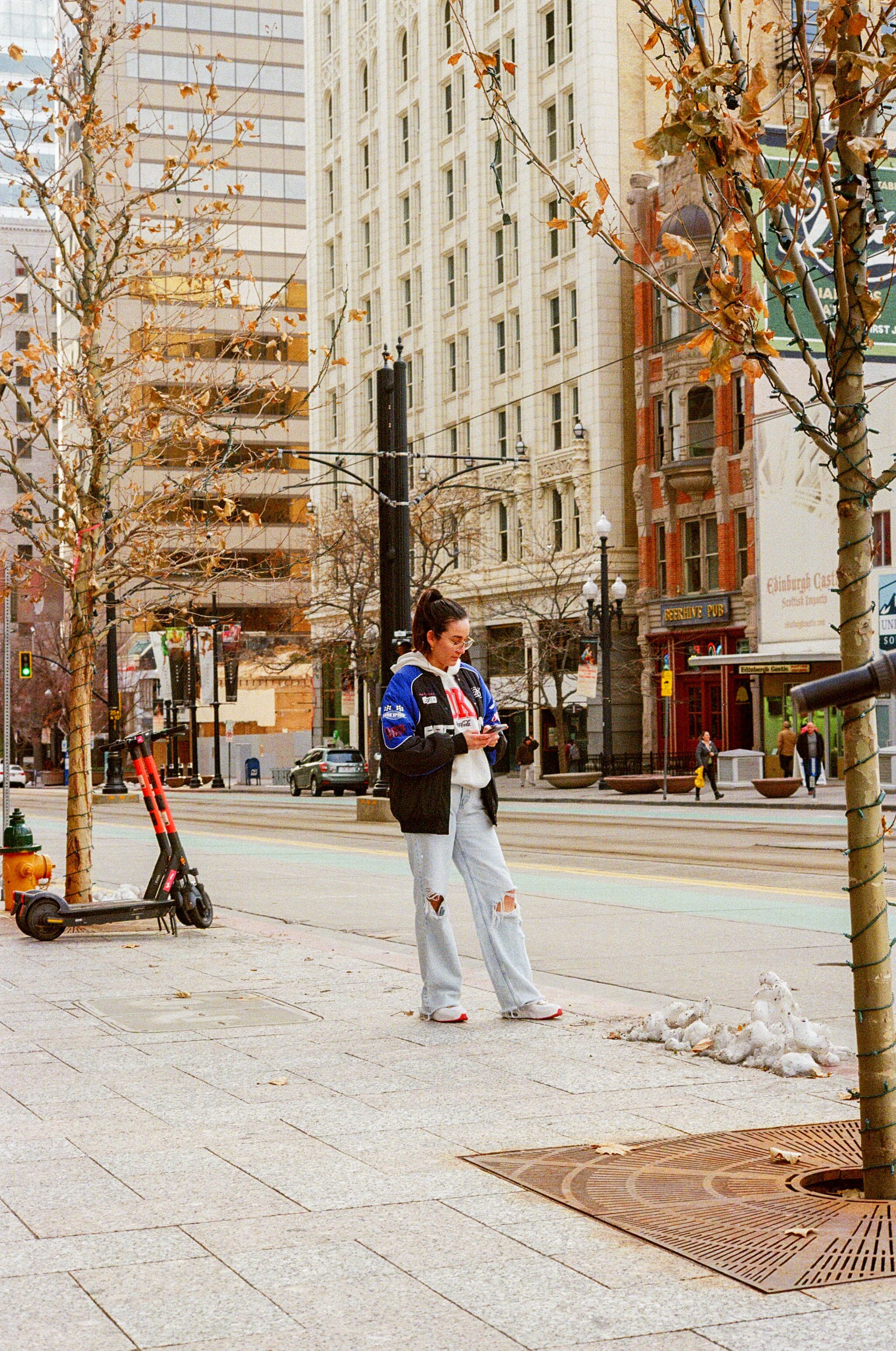 Woman Standing on Sidewalk in City · Free Stock Photo