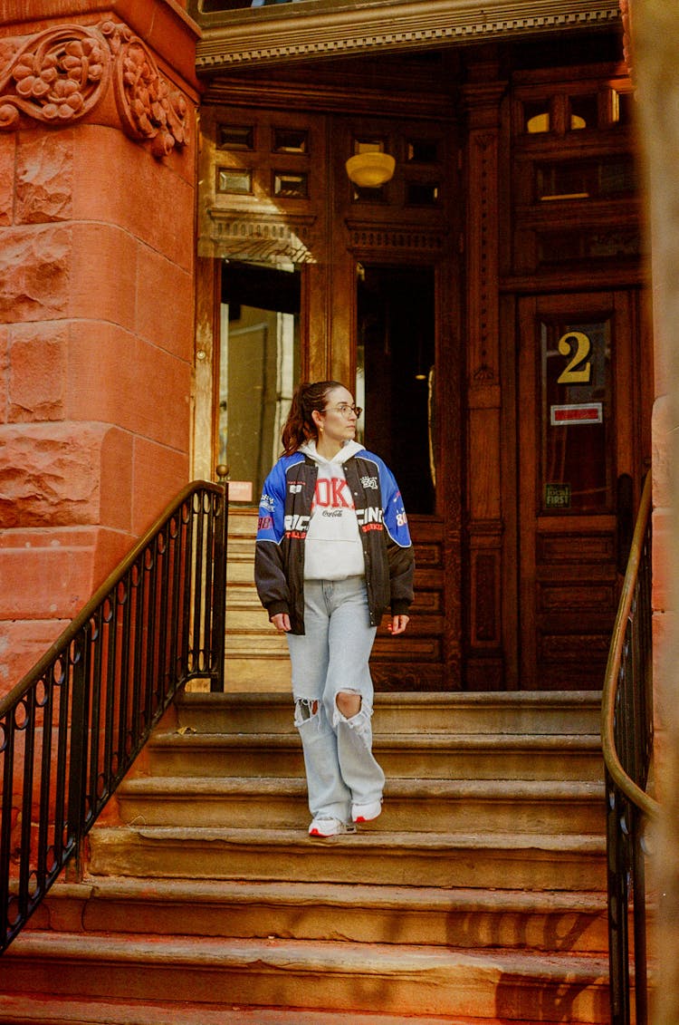 A Woman Standing On The Stairs