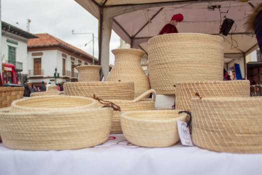 A vibrant display of handmade straw baskets at an outdoor market in Cuenca, Ecuador.