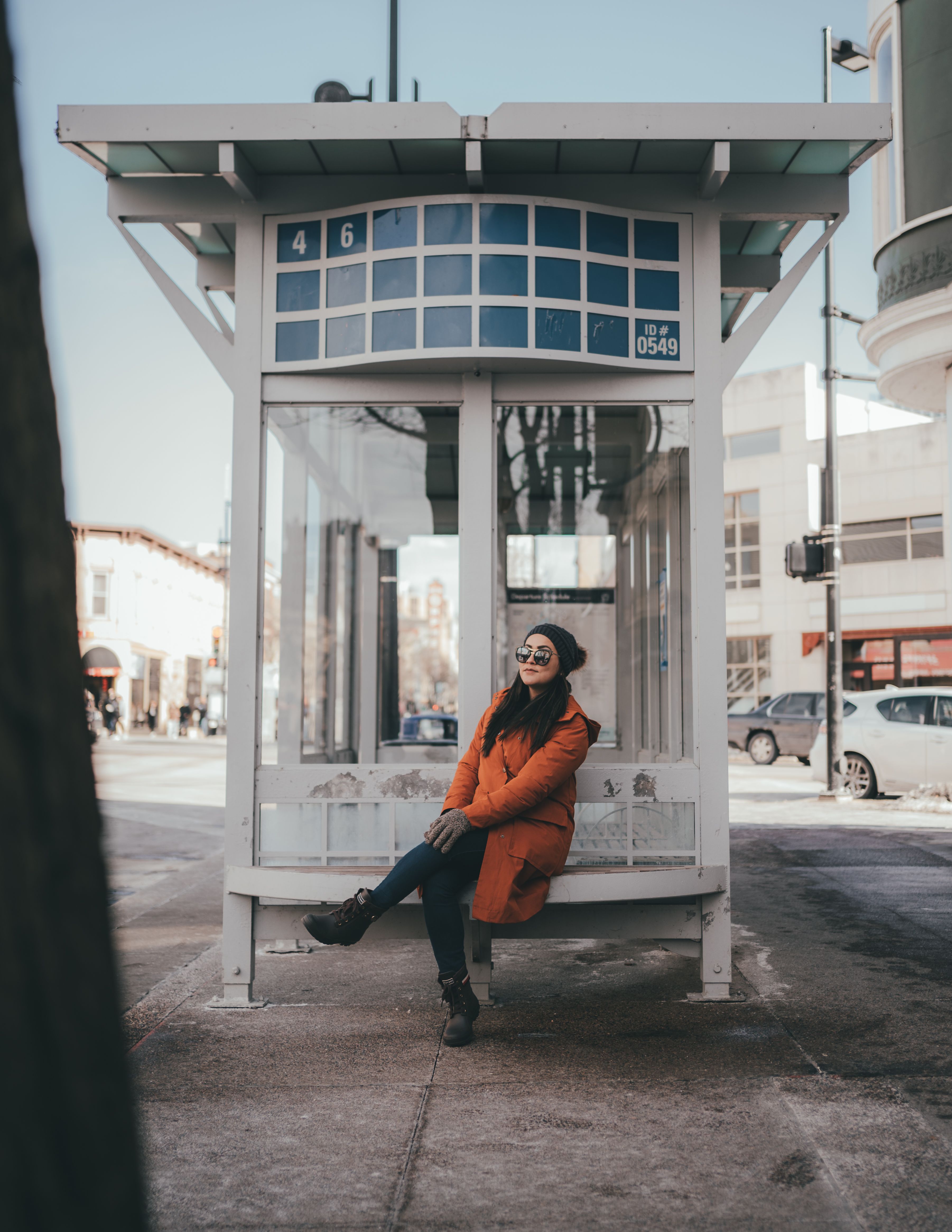 A Woman in Brown Coat Sitting on the Bus Stop · Free Stock Photo