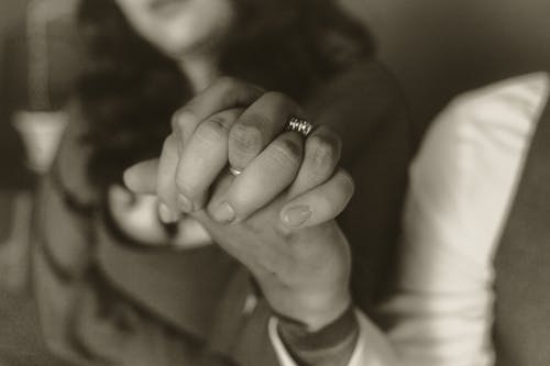 Monochrome Photo of Holding Hands