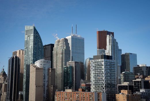 Aerial view of Toronto's iconic skyline featuring modern skyscrapers under a clear blue sky.