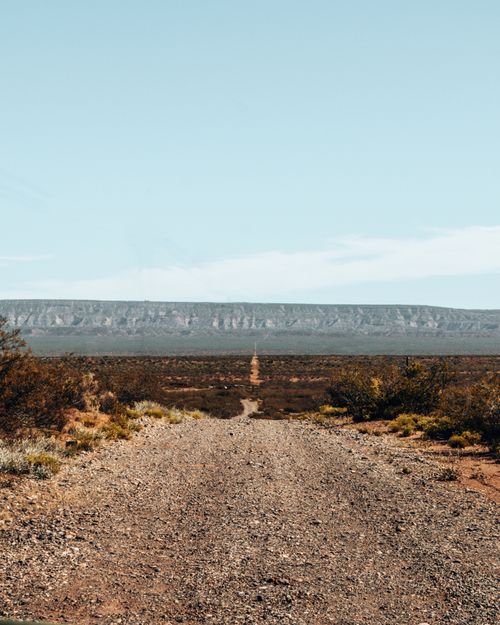 Free Rugged path stretches through the scenic desert landscape of Neuquén, Argentina. Stock Photo