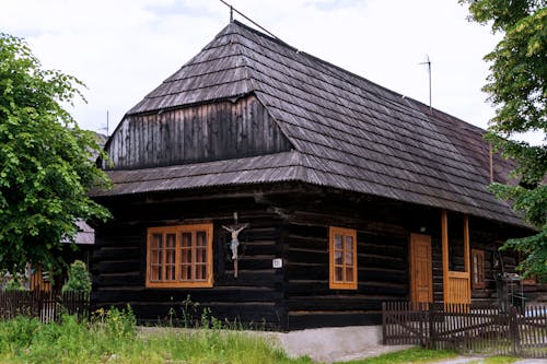 View of a Wooden House with a Figure of Jesus on the Cross 