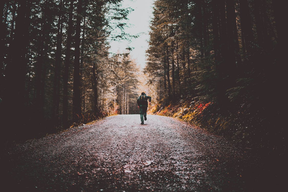 Person Running on Dirt Road