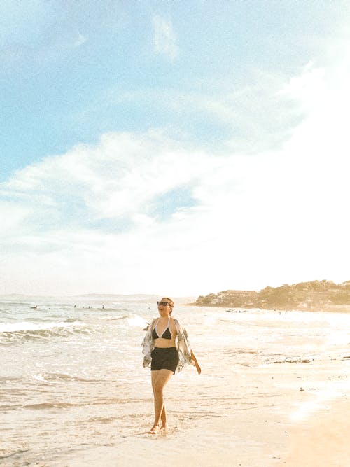 Happy Woman Walking on a Beach 