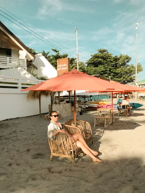 Free Woman enjoying a sunny day at San Juan Surf Resort beach, Philippines. Stock Photo