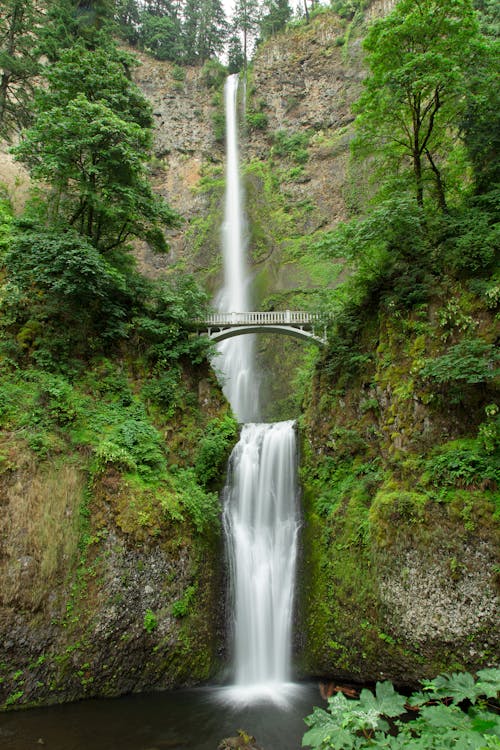 Waterfall and Mountainside with a Bridge 