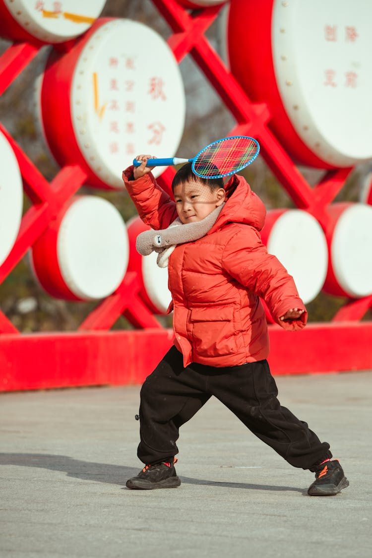 Child With Racket Playing Badminton Outdoors