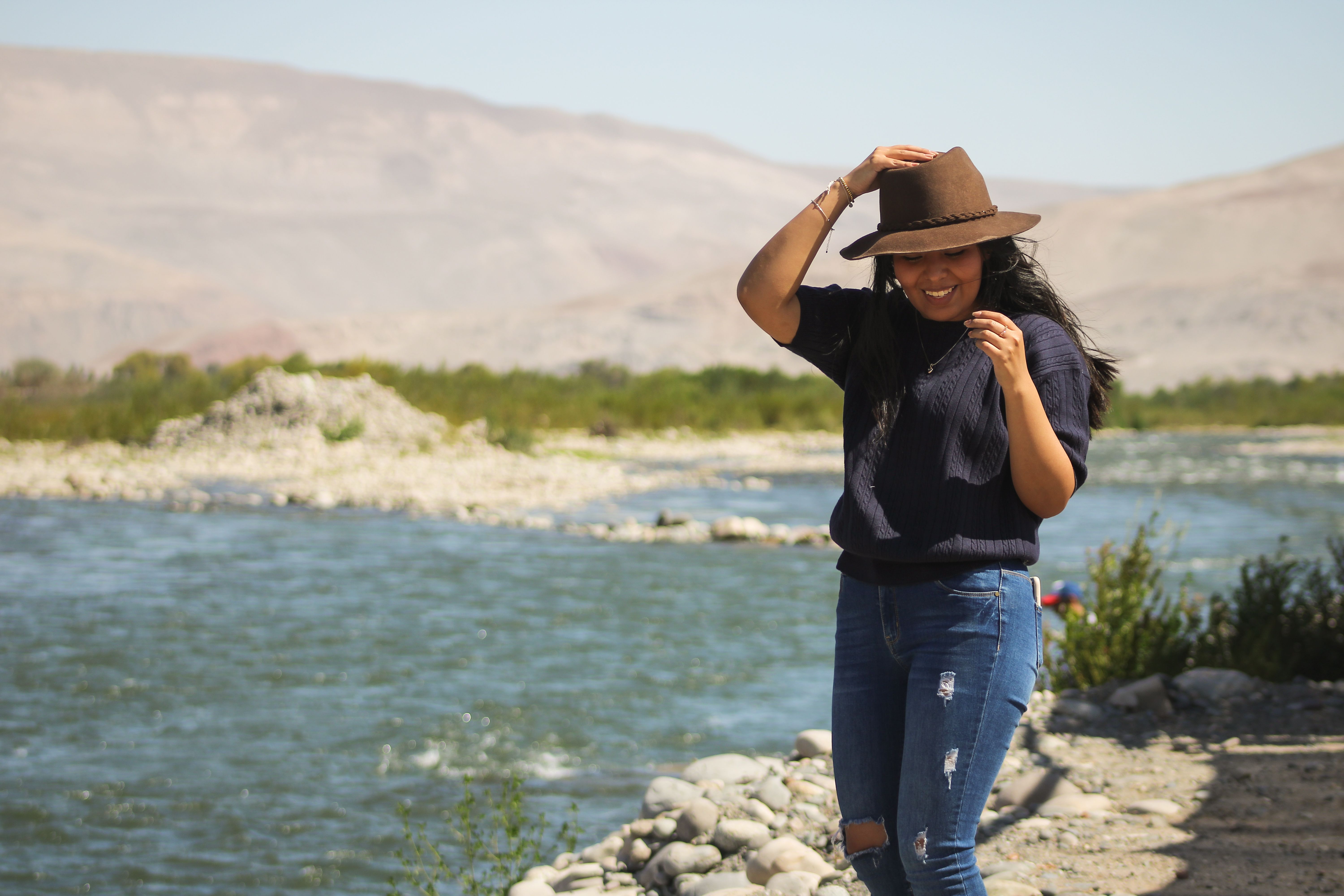 A woman enjoying a sunny day by the river in Majes, Arequipa, Peru.