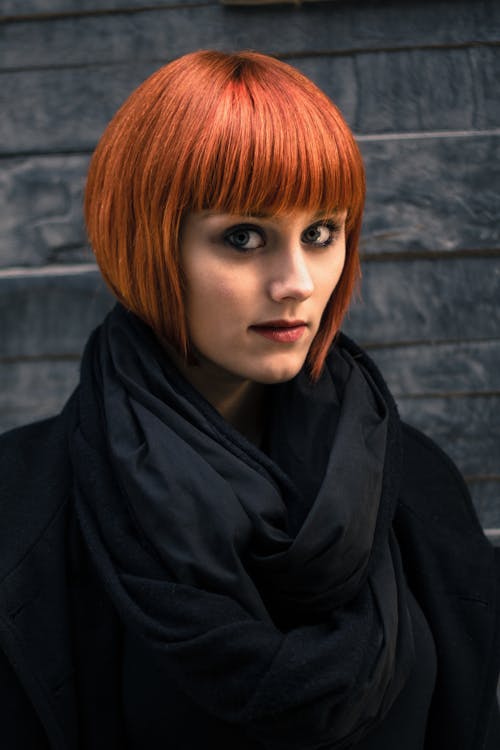 Woman in Red Hair and Black Coat