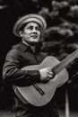 Grayscale Photography of Man Playing Guitar