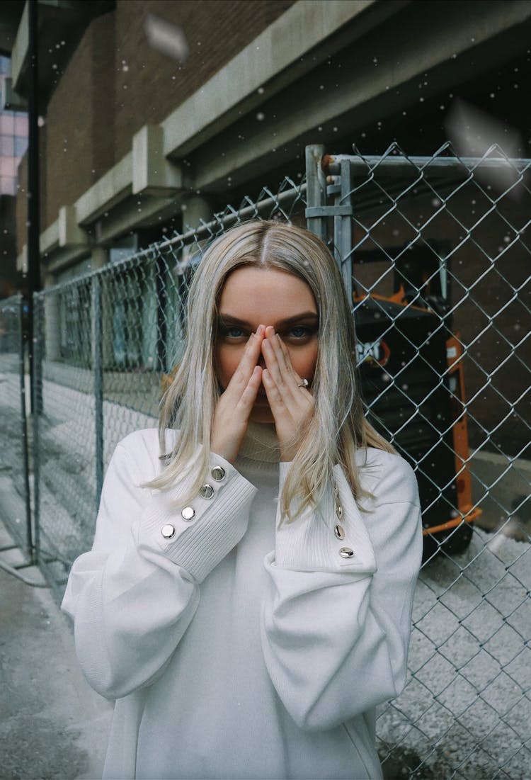 Portrait Of Blonde Woman Covering Face