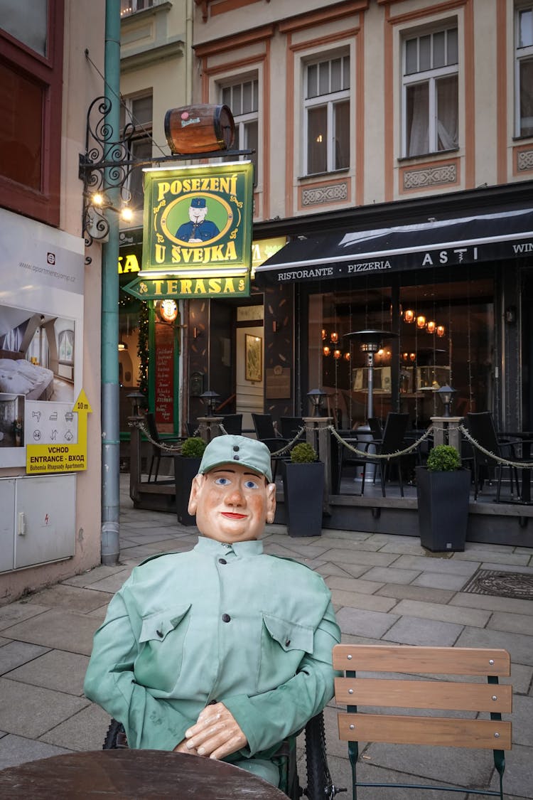 Soldier Mannequin Sitting On Outdoor Restaurant Terrace