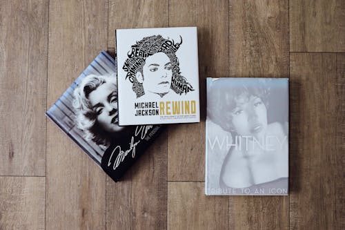 Free Three books on a wooden floor with a photo of marilyn monroe Stock Photo