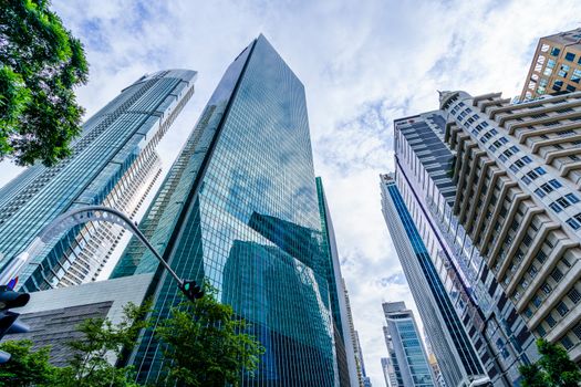 Low angle view of modern skyscrapers against a blue sky in an urban downtown setting.
