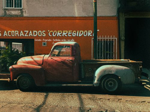Free Rusty retro pickup truck parked on a sunny street in Emiliano Zapata, Mexico. Stock Photo