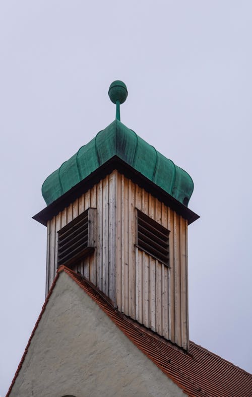 Close-up of a Tower of a Church under a Cloudy Sky 