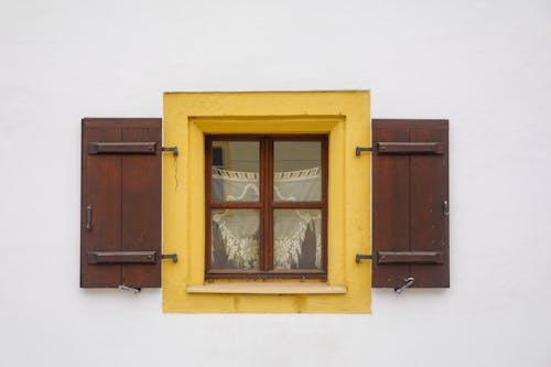 Yellow Cottage Window in White Wall