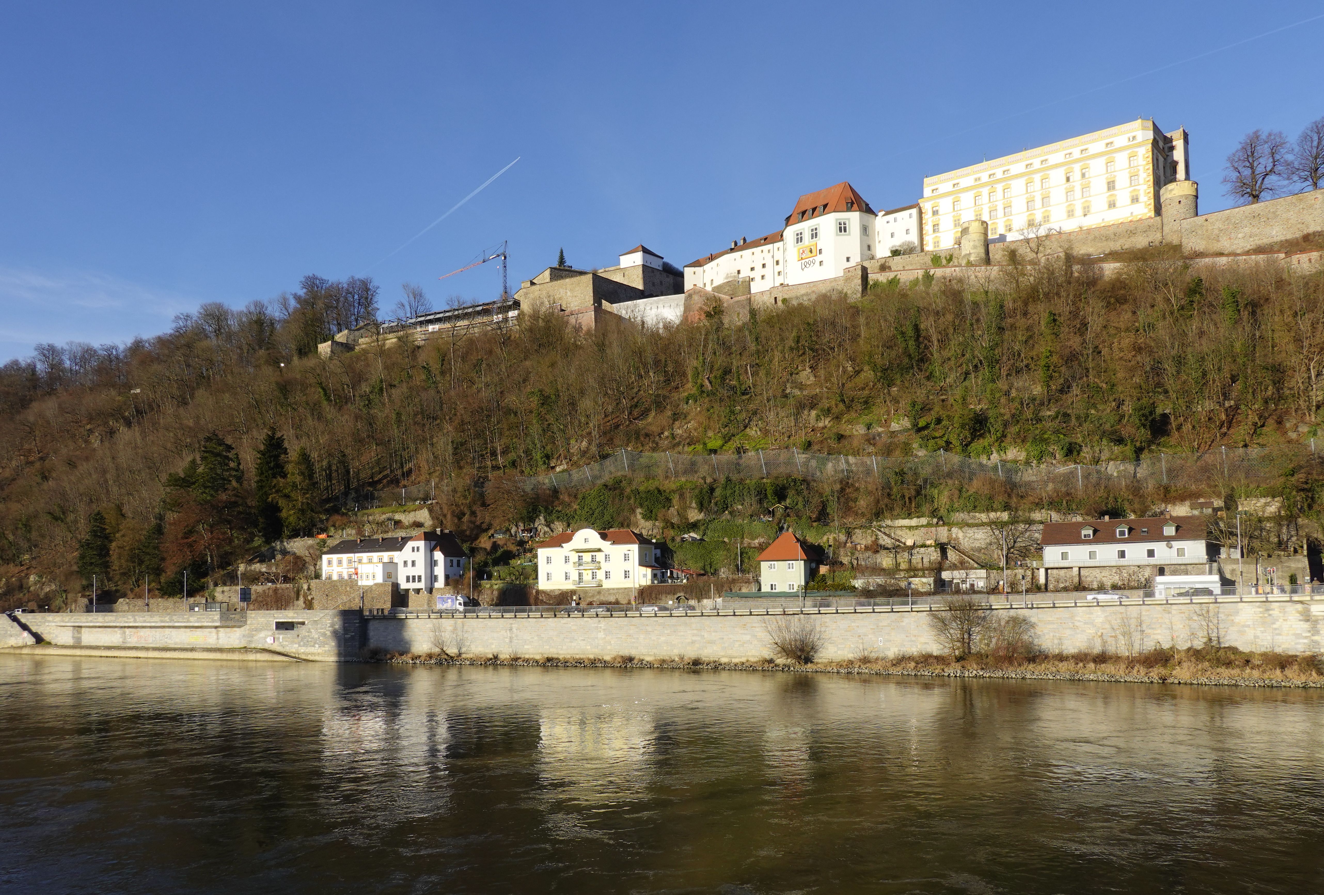 Scenic view of Veste Oberhaus and charming hillside buildings in Passau, Germany.
