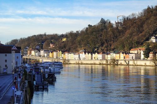 Free Picturesque view of colorful buildings along the riverbank in Passau, Germany. Stock Photo