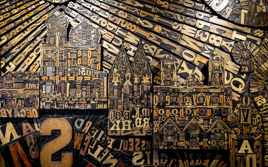 Wall of assembled wood letterpress type — photo by Magda Ehlers on Pexels