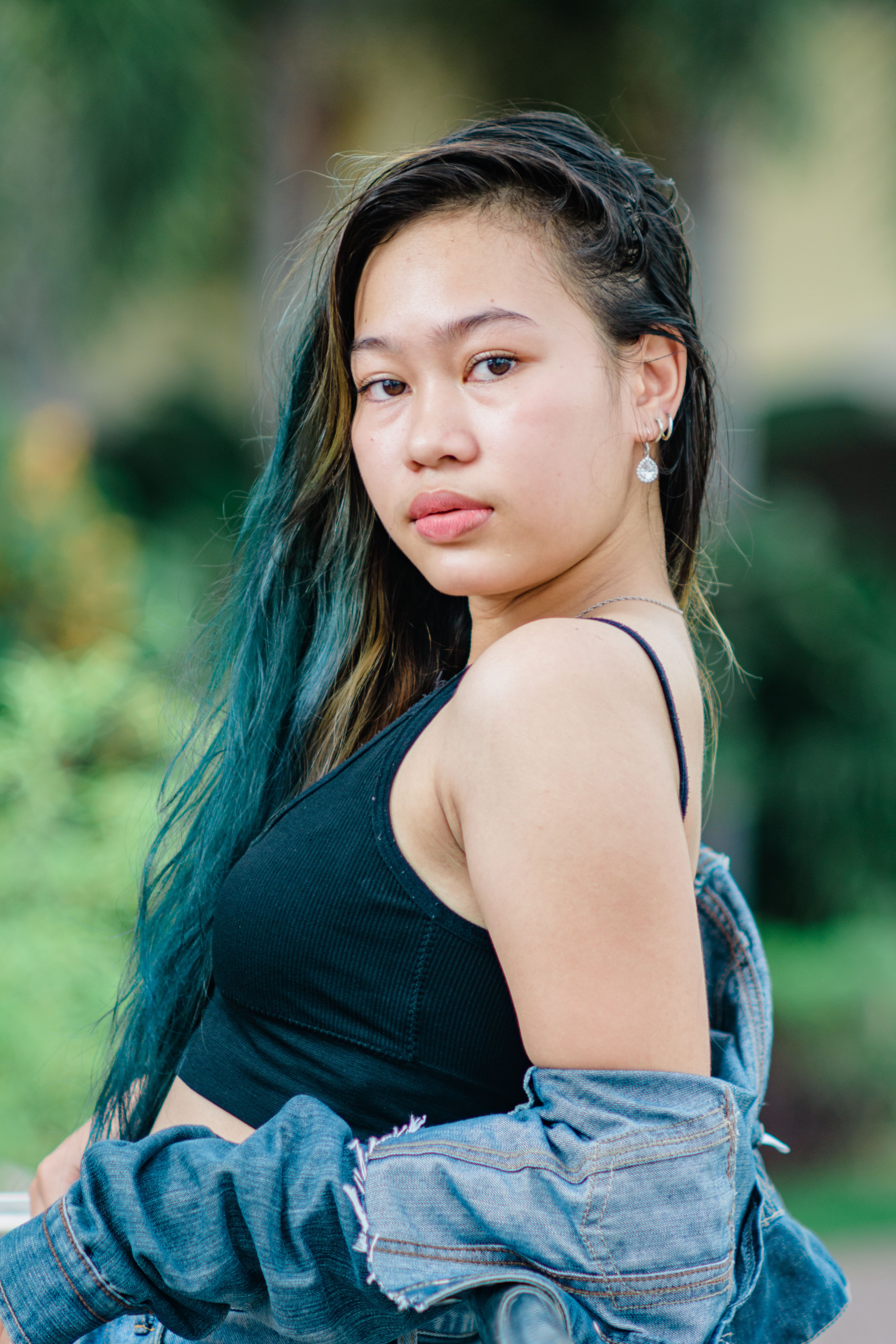 Portrait of a fashionable teenager in a casual outfit outdoors, showcasing modern style.