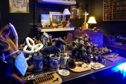 Free A cozy Passau shop window showcases dachshund-themed decor and ceramics, emitting a warm glow. Stock Photo