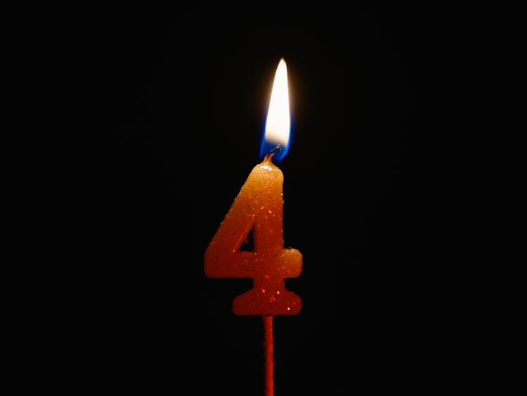 A Lighted Number Candle On A Black Background