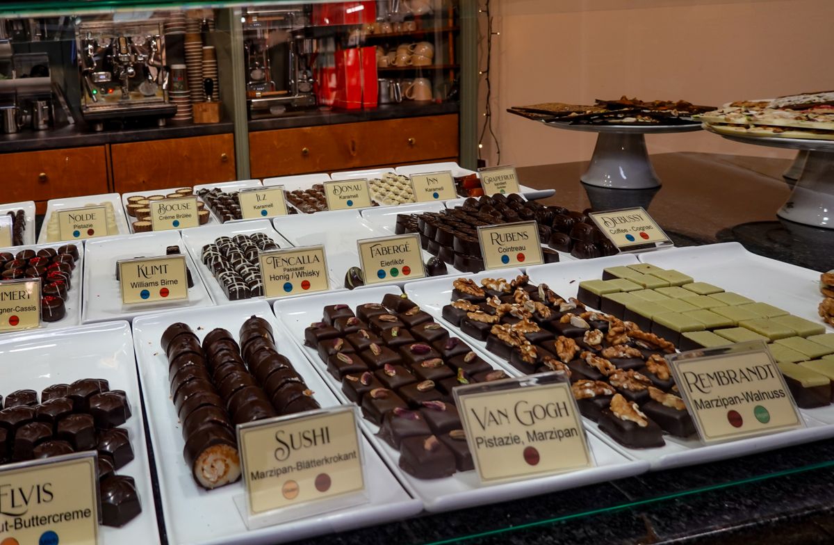 A tempting array of gourmet chocolates on display in a café. Perfect for dessert lovers.